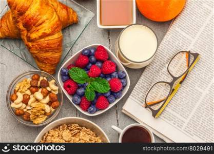 Top view of breakfast meal over wooden table