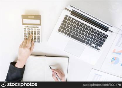top view of business financier audit working with laptop and calculator