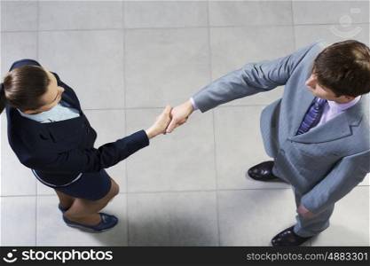 Top view of business partners shaking hands as a symbol of unity. Glad to be your partner