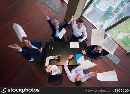 top view of business people group on meeting throwing documents in air