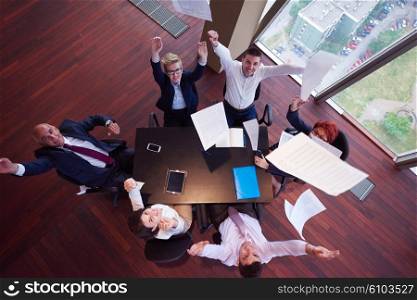 top view of business people group on meeting throwing documents in air