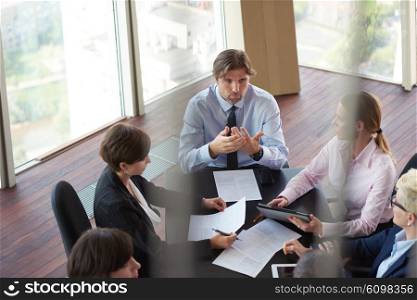 top view of business people group on meeting, working in modern bright office indoor with tablet computer