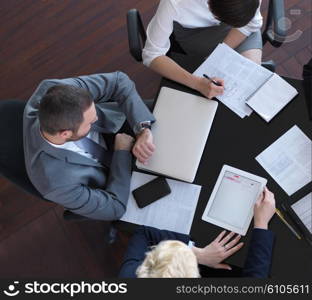top view of business people group on meeting, working in modern bright office indoor with tablet computer
