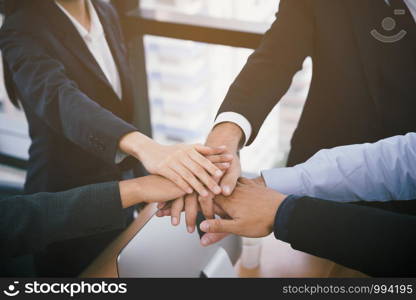 Top view of business people put hands together. Teamwork at office and business group concept
