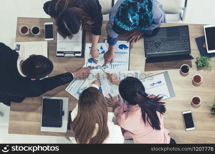 Top view of businessman executive in group meeting with other businessmen and businesswomen in modern office with laptop computer, coffee and document on table. People corporate business team concept.