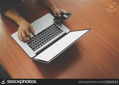 top view of businessman hand using on smart phone and blank screen laptop computer as concept