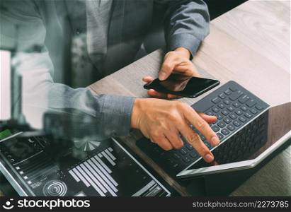 top view of businessman hand using smart phone,mobile payments online shopping,omni channel,digital tablet docking keyboard computer,documnets,in modern office on wooden desk,filter