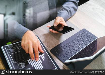 top view of businessman hand using smart phone,mobile payments online shopping,omni channel,digital tablet docking keyboard computer,documnets,in modern office on wooden desk,filter