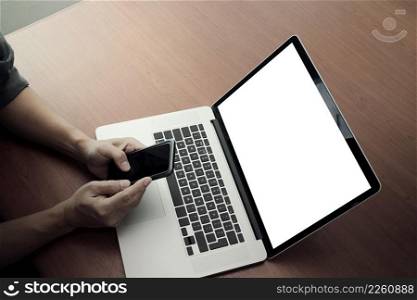 top view of businessman hand working with new modern computer and smart phone and business strategy on wooden desk with social media network as concept