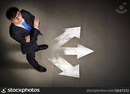 Top view of businessman standing against directions background