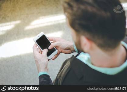 Top view of businessman using smartphone at outdoor of the office building