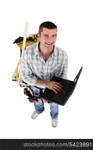 Top-view of carpenter with laptop