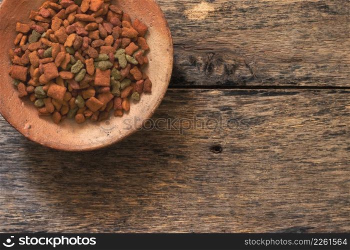 Top view of Cat food in the cat bowl on wood background