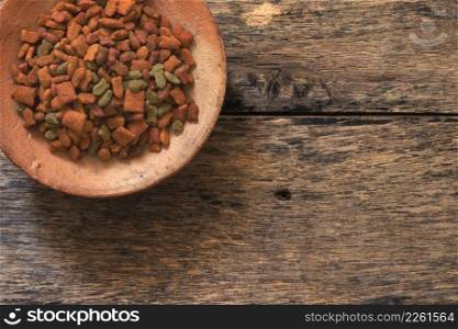 Top view of Cat food in the cat bowl on wood background
