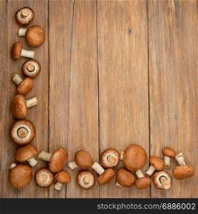 Top view of champignons on a wooden kitchen table.