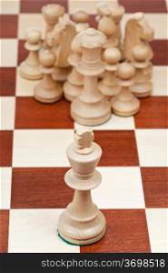 top view of chess pieces against the king close up