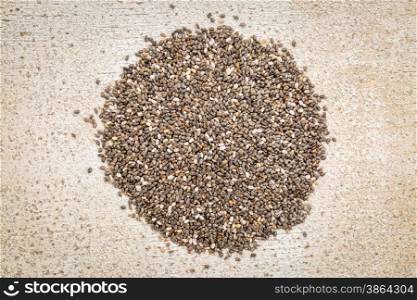 top view of chia seeds pile against rustic white painted barn wood