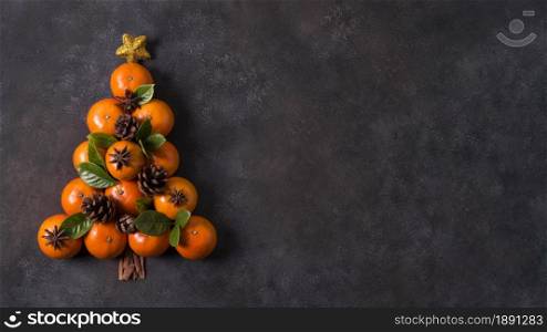 top view of christmas tree shape made of tangerines and pine cones with copy space. Resolution and high quality beautiful photo. top view of christmas tree shape made of tangerines and pine cones with copy space. High quality and resolution beautiful photo concept