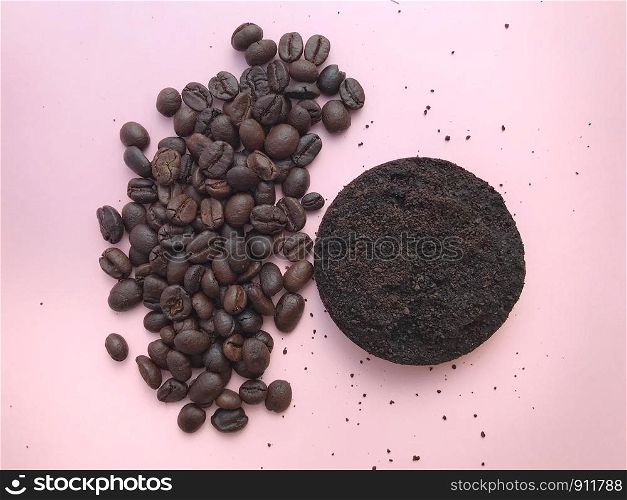 Top view of Coffee beans and grounds on pink background