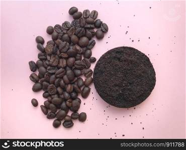 Top view of Coffee beans and grounds on pink background