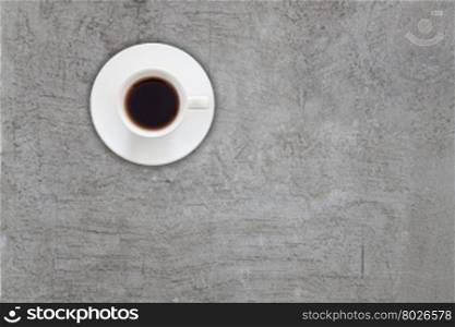 Top view of coffee cup on abstrsct gray concrete texture background