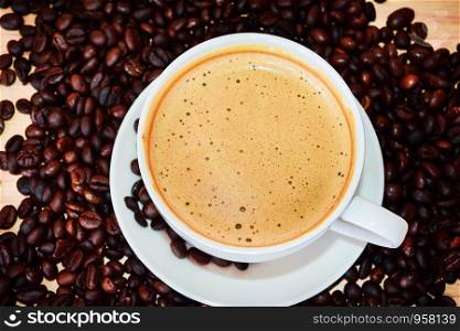 Top view of coffee milk with beans on wooden table for coffee shop concept,Food and drink