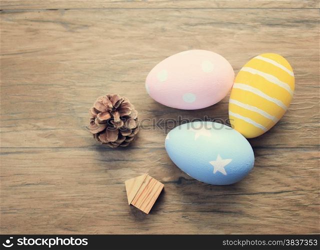 Top view of colorful easter eggs on wooden background with retro filter effect