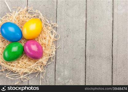 Top view of colorful easter eggs over wooden table
