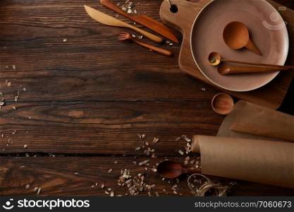 Top view of cooking wooden utensils with space for text on wooden background. Vintage kitchen utensils for cooking