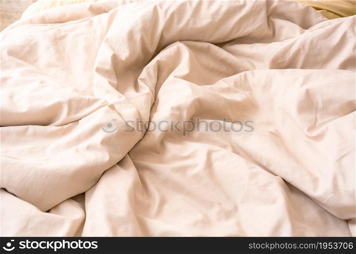 Top View Of Cream Blanket That Wrinkles On The Bed After Sleep In A Long Night.