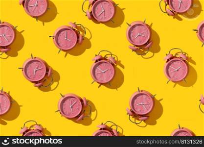 Top view of creative pattern made of pink alarm clocks on a yellow background, flat lay. Wake-up and good morning concept. Punctuality. Countdown and deadline. Sleeping time. Daily regime. Business planning. Top view. 3d rendering