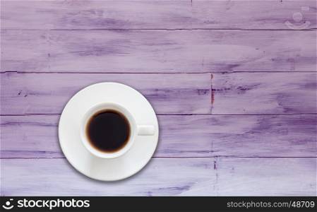 Top view of cup of fresh espresso on purple wooden background