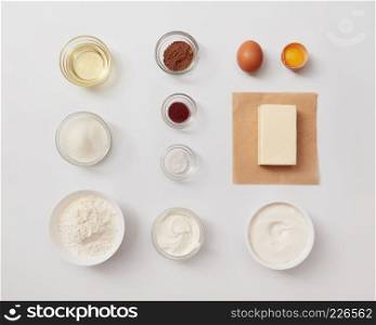 Top view of different ingredients for baking or cooking represented separately over white background. Ingredients for cooking cakes or breads.. Ingredients for baking or cooking