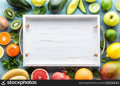 top view of different selected juicy organic tropical fruits, superfood, healthy eating concept, frame with blank space for a text