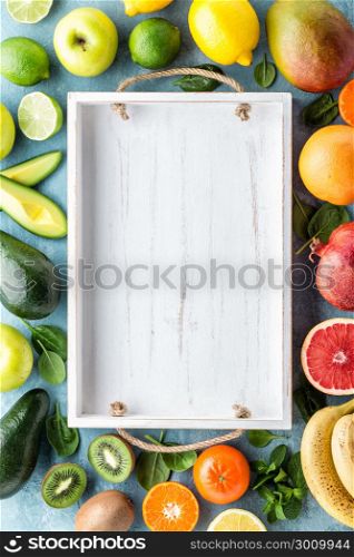 top view of different selected juicy organic tropical fruits, superfood, healthy eating concept, frame with blank space for a text