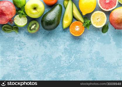 top view of different selected juicy organic tropical fruits, superfood, healthy meal concept, healthy food background