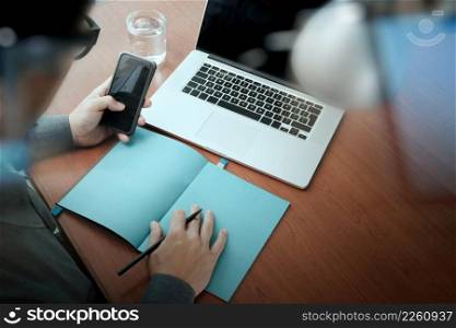 top view of Double exposure of businessman hand working with mobile phone and modern computer and business strategy as concept