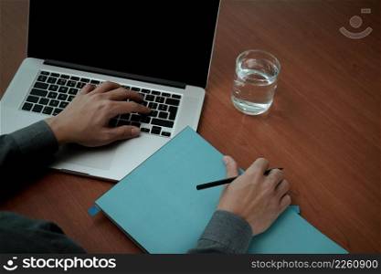 top view of Double exposure of businessman hand working with new modern computer and business strategy and blank book as concept