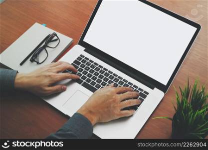 top view of Double exposure of businessman hand working with new modern computer laptop with blank screen and blank book as concept