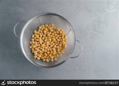 Top view of dry fresh chickpeas or garbanzo in sieve. Organic ingredient. Healthy product full of protein and vitamins. Garbanzo for vegans
