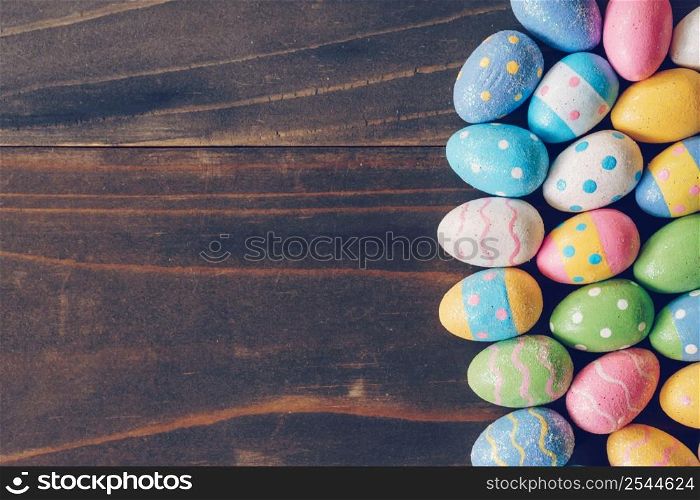 Top view of Easter eggs on rustic wood background with copy space