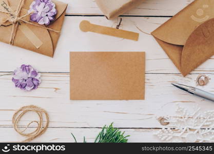 Top view of empty christmas card on wooden table with xmas decoration.