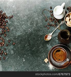 Top view of Espresso coffee, milk and sugar on black marble table. Background with space for text.