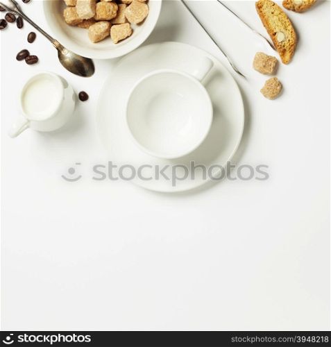 Top view of Espresso coffee, milk and sugar on white. Background with space for text