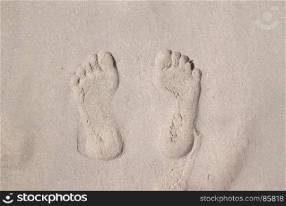Top view of footprints on sand beach