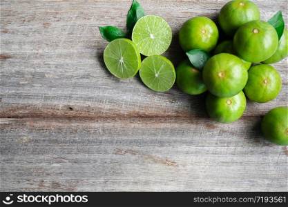 Top view of fresh citrus lemon lime on wooden background, copy space.