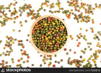 top view of fresh green and orange peppercorns in wooden bowl on white background
