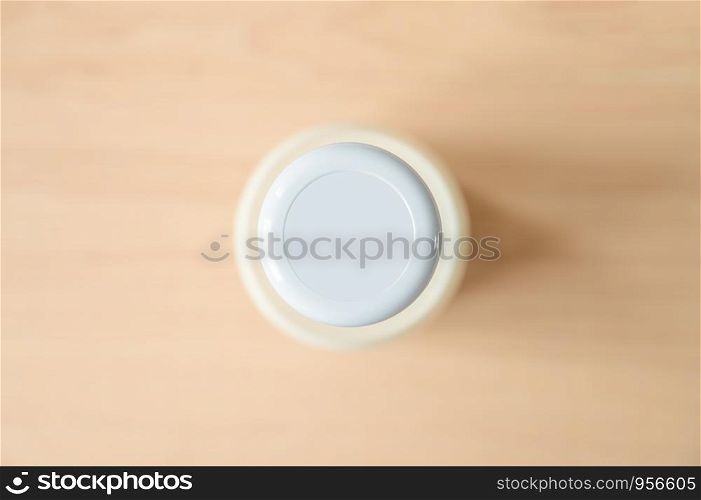 Top view of fresh milk in the traditional glass bottles on wooden table near the window. Copy space wallpaper.
