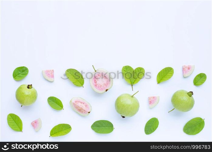 Top view of fresh ripe guava and slices with leaves on white background. Copy space