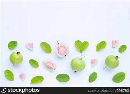 Top view of fresh ripe guava and slices with leaves on white background. Copy space